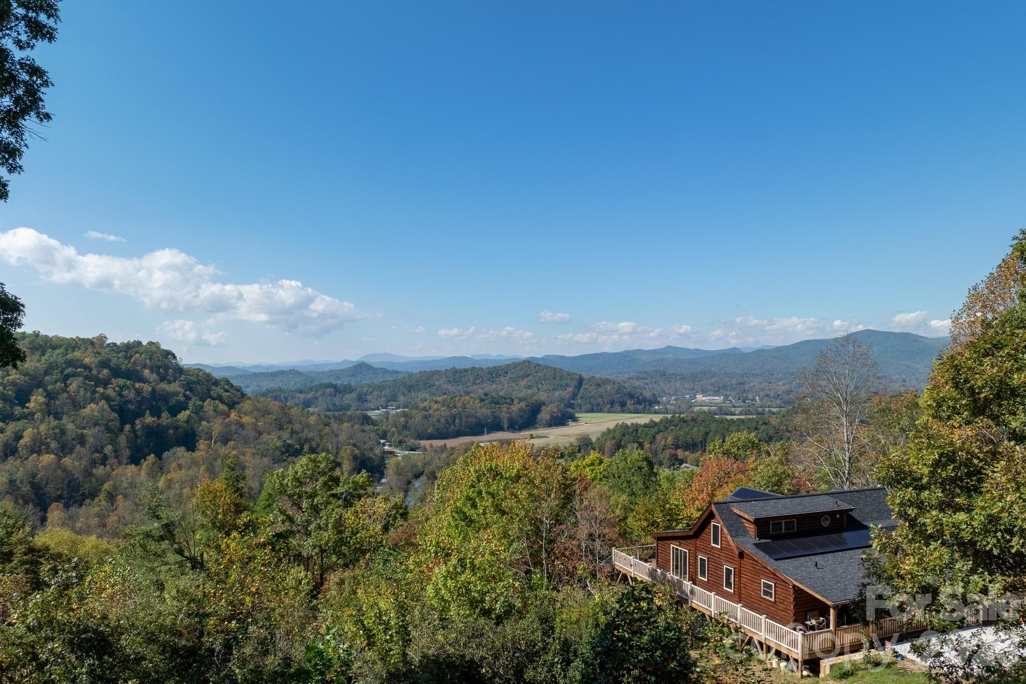 Sweeping panoramic views across wooded hillsides, open valleys, and distant Blue Ridge Mountain ridgelines. - 524 Three Mile Knob Road, Pisgah Forest