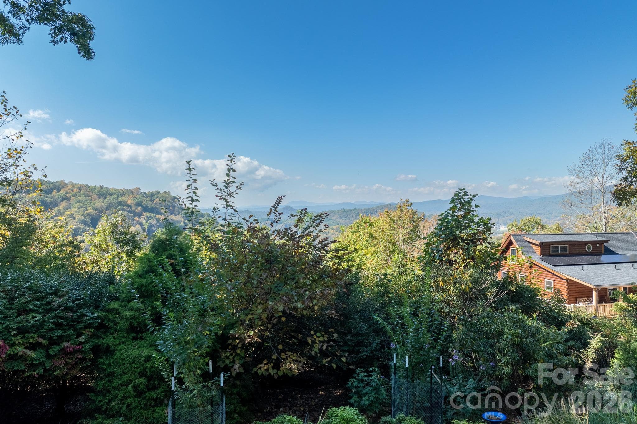 Beautiful mountain scenery with layers of distant ridgelines and mature landscaping creating a peaceful natural setting. - 524 Three Mile Knob Road, Pisgah Forest