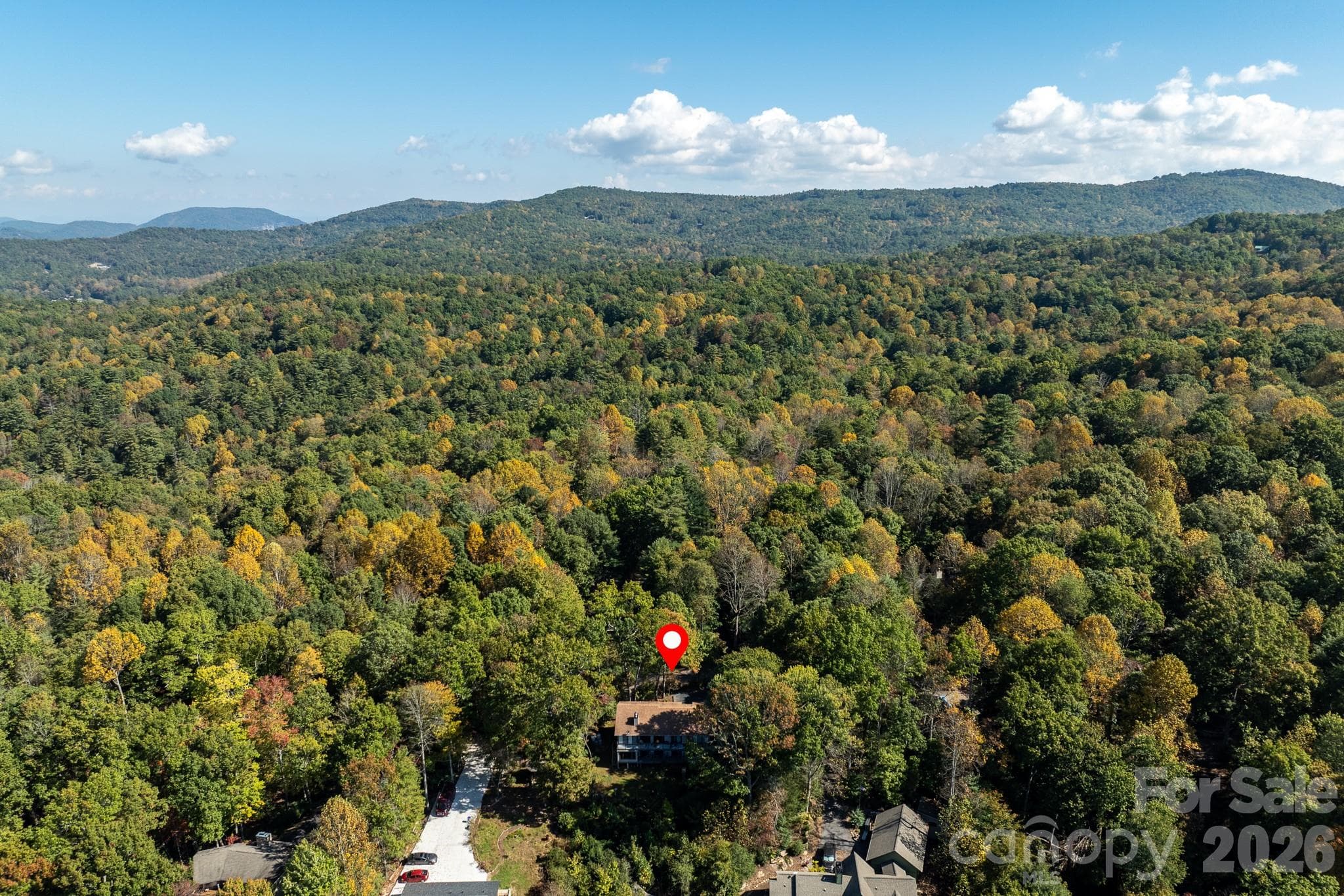 Aerial perspective highlighting the property's wooded mountain setting and surrounding natural beauty. - 524 Three Mile Knob Road, Pisgah Forest