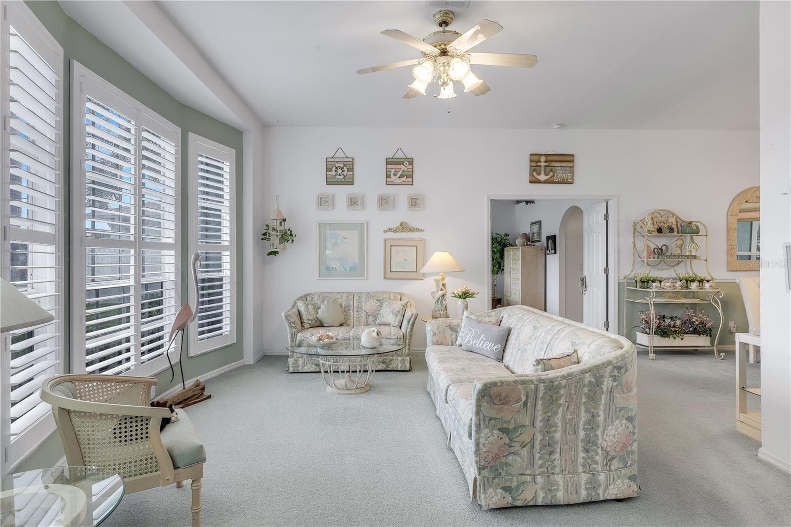 Bright living room with high ceiling and planation shutters. - 305 SE 31ST ST, CAPE CORAL