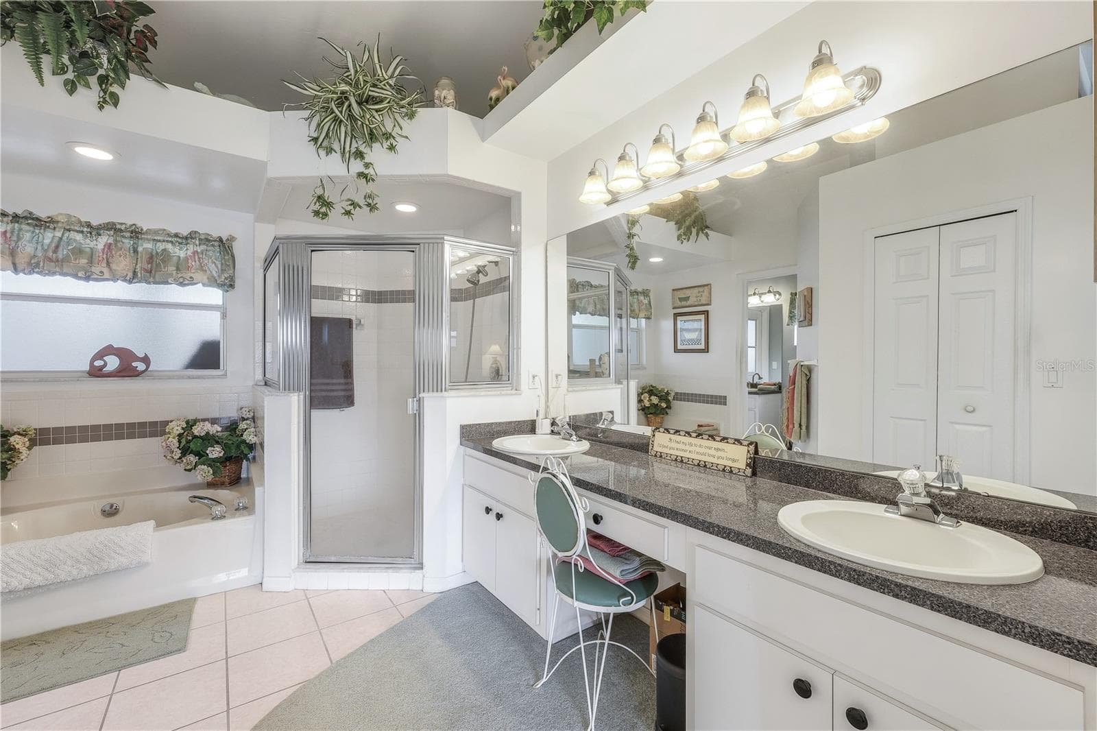 Primary bathroom with dual sink vanity, step-in shower and soaking tub. - 305 SE 31ST ST, CAPE CORAL
