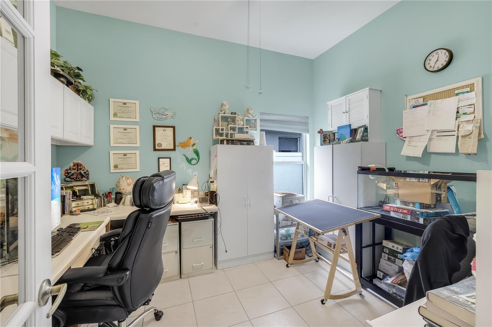 Den/office with built-in cabinets and desk. Could be converted into a 4th bedroom. - 305 SE 31ST ST, CAPE CORAL