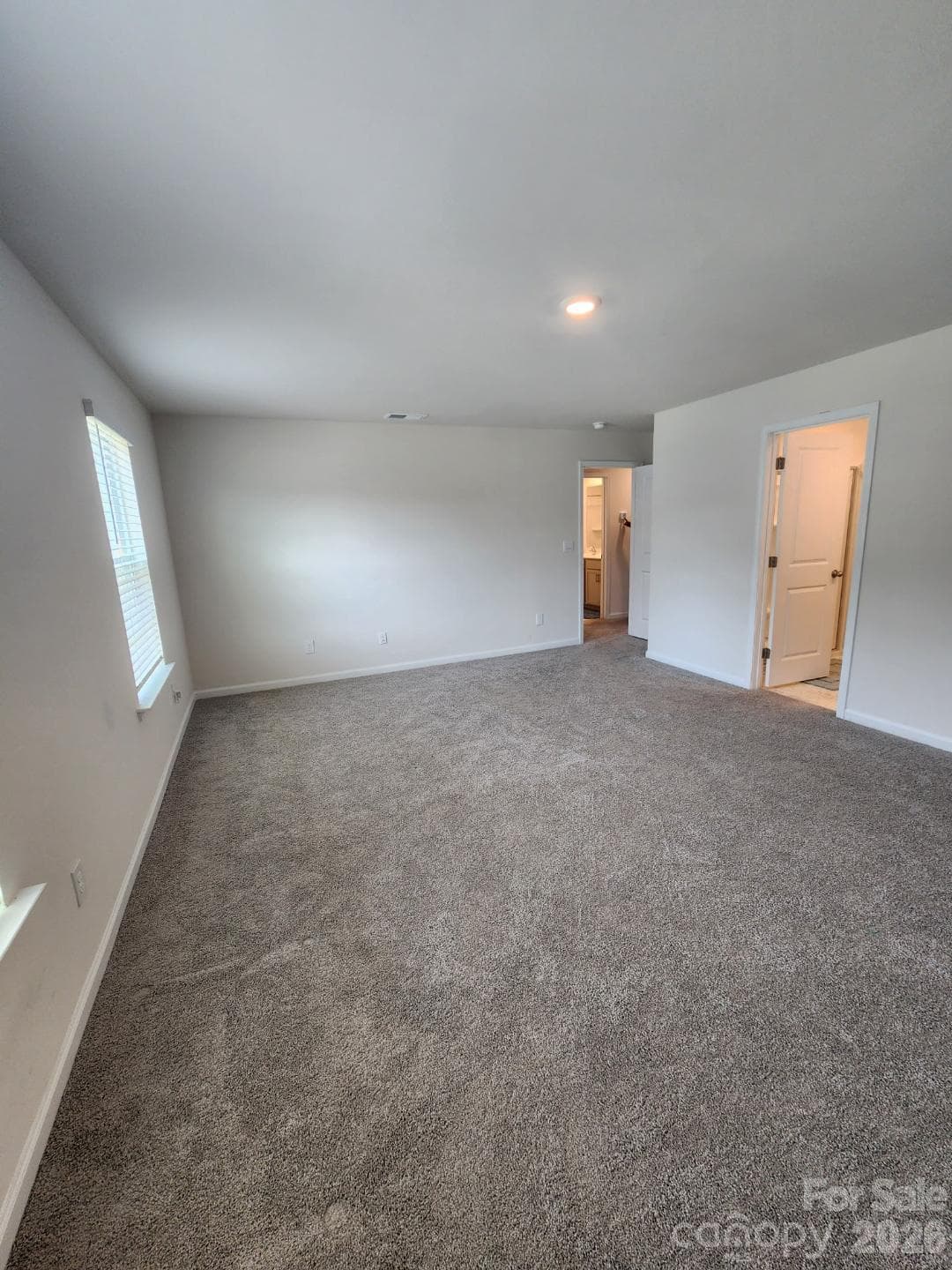 Prepare to be impressed by this massive primary bedroom, offering an expansive layout that effortlessly accommodates oversized furniture and a cozy relaxation space. Two large windows fill the room with light to create a bright, peaceful space complete with a generous walk-in closet. - 3741 Stanley Creek Drive, Mount Holly
