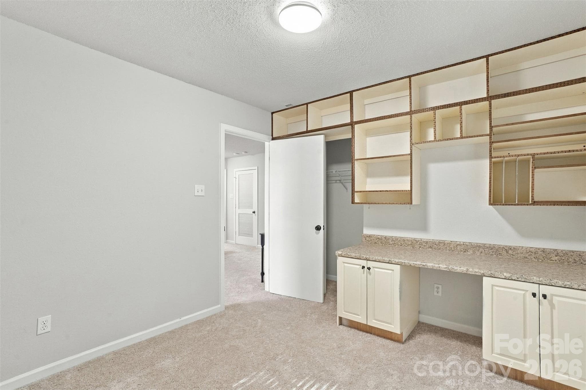 Secondary bedroom with built-in desk and organizer. - 1901 Beckwith Lane, Waxhaw