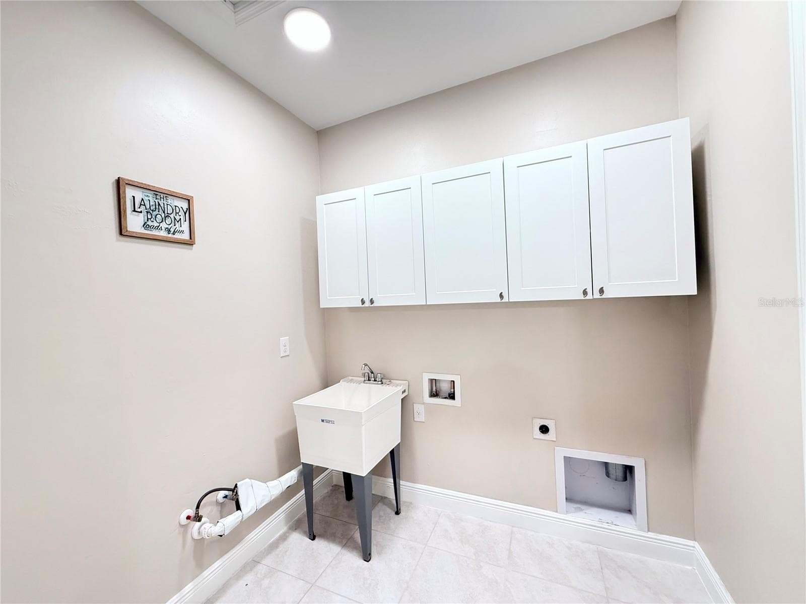 Laundry room with utility sink and cabinets! - 10320 LANDS END CIR #47, PLACIDA