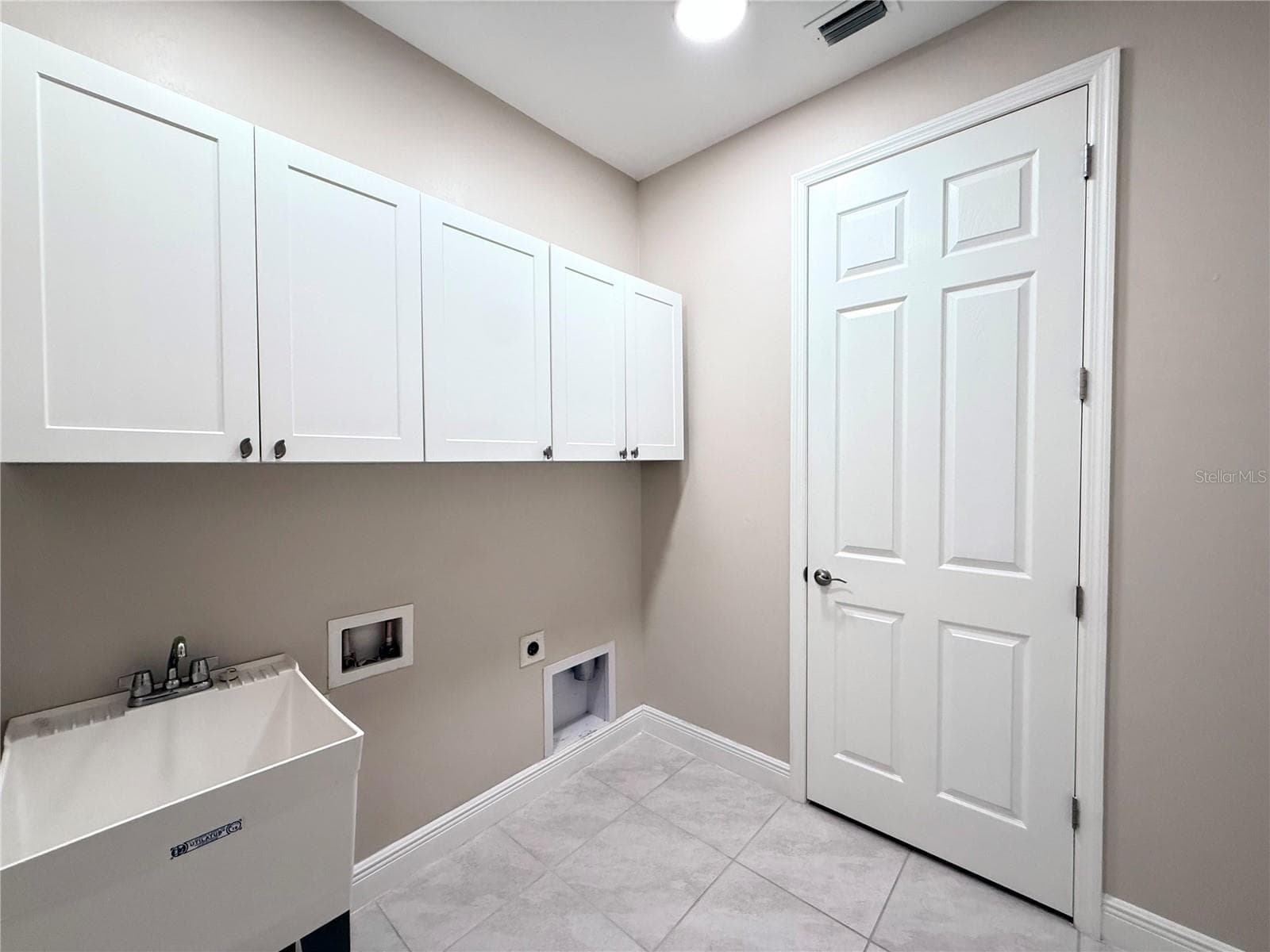 Laundry room with utility sink and cabinets! - 10320 LANDS END CIR #47, PLACIDA