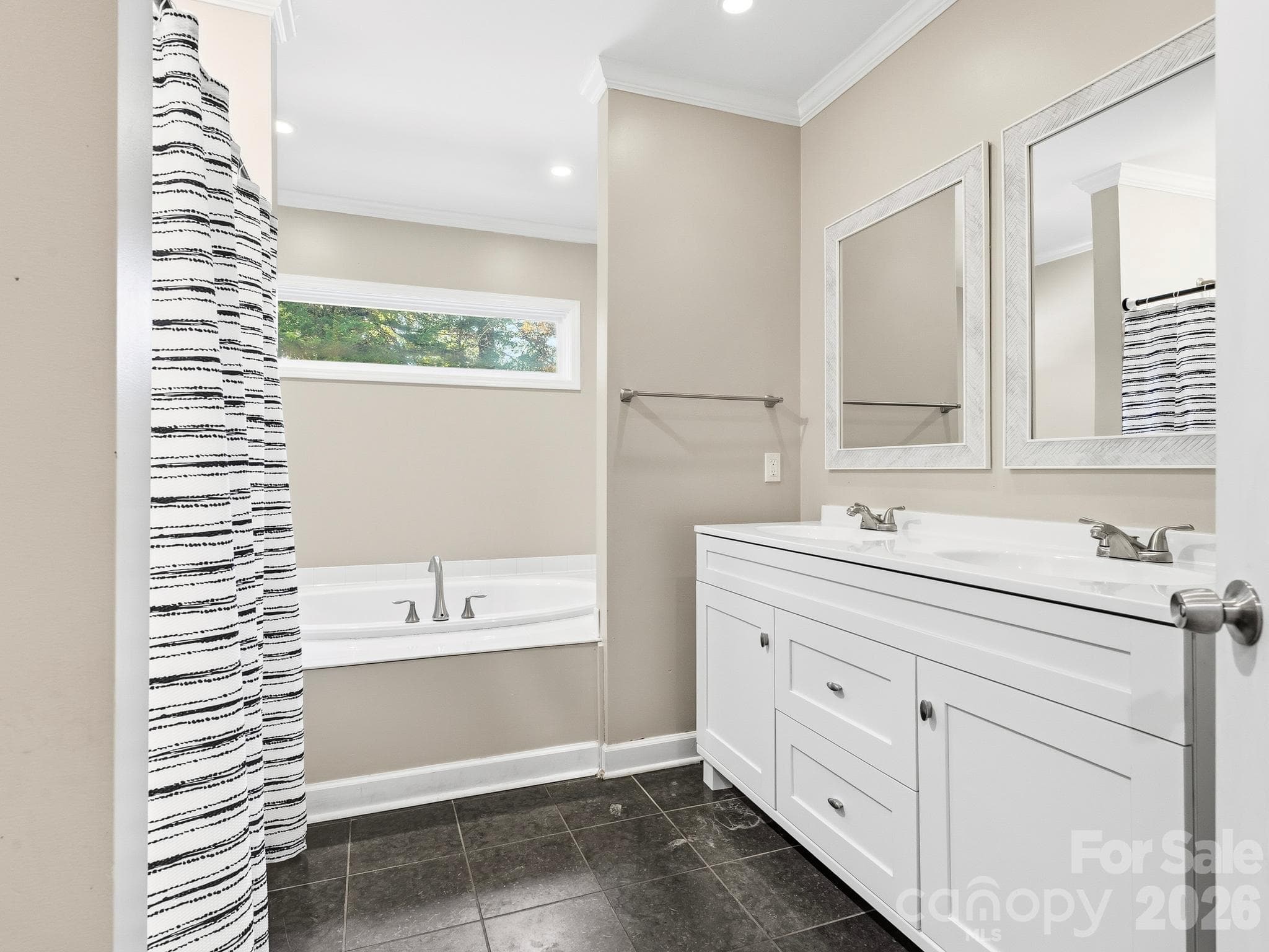 The primary ensuite bathroom features a soaking tub and a walk-in shower - 175 Mimosa Road, Columbus