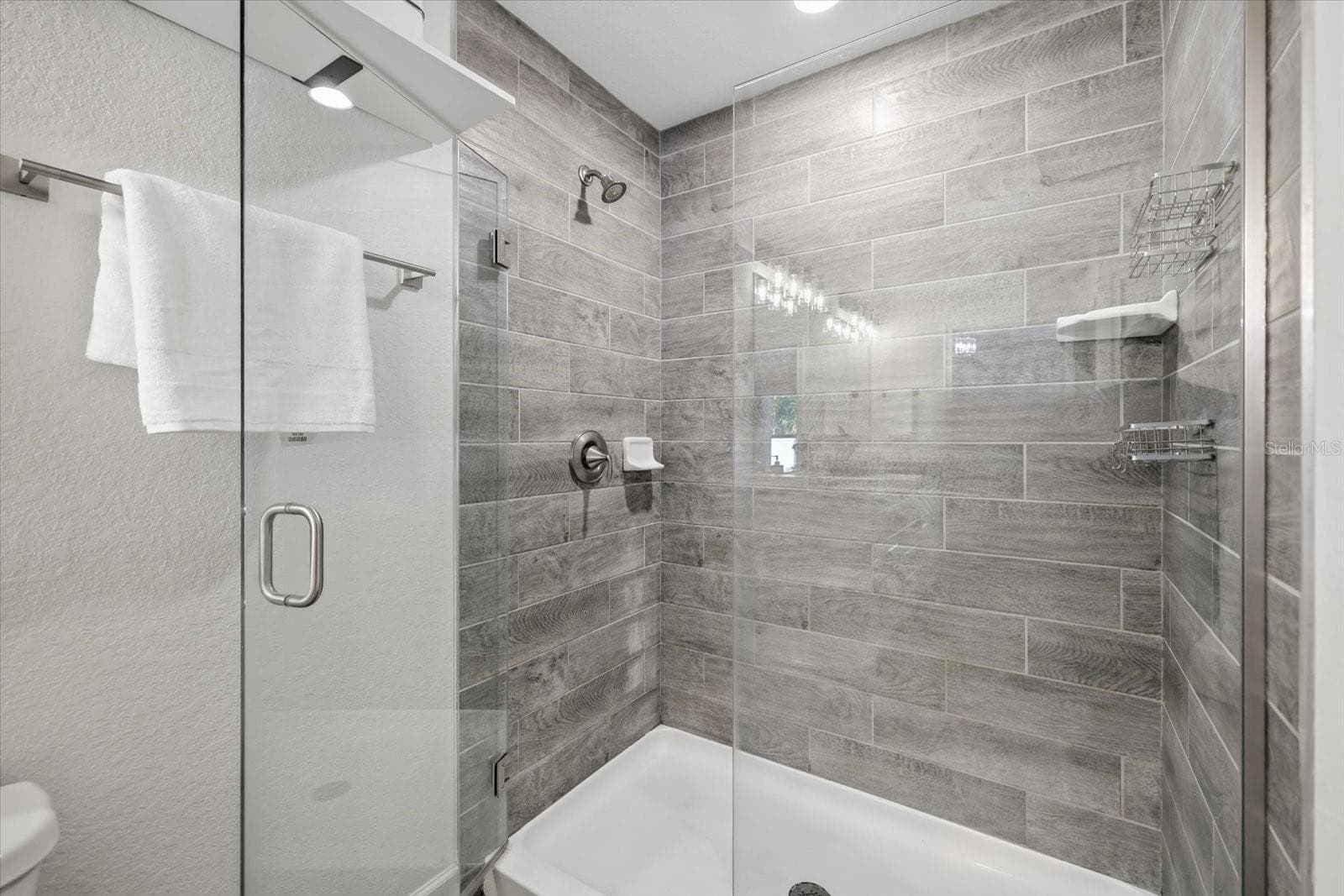 Beautiful shower with floor to ceiling tile with glass doors - 300 FORDHAM RD, VENICE