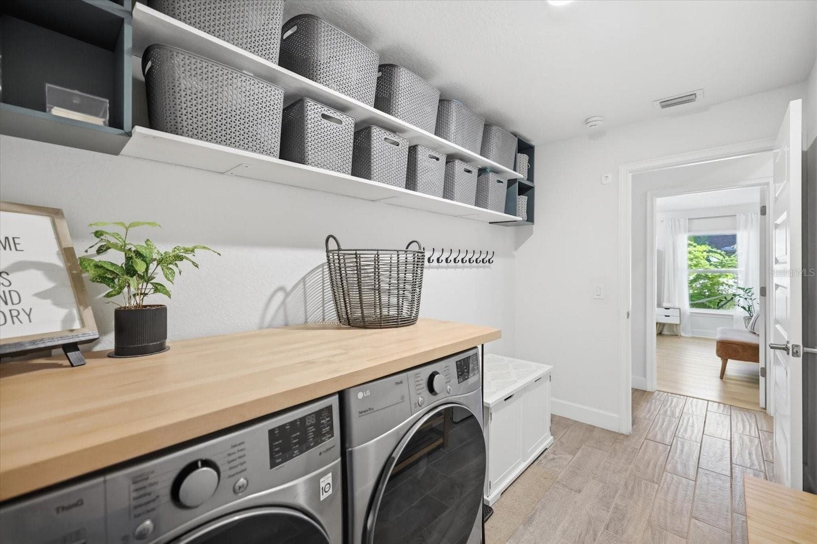 Laundry room with practical storage shelves. - 300 FORDHAM RD, VENICE
