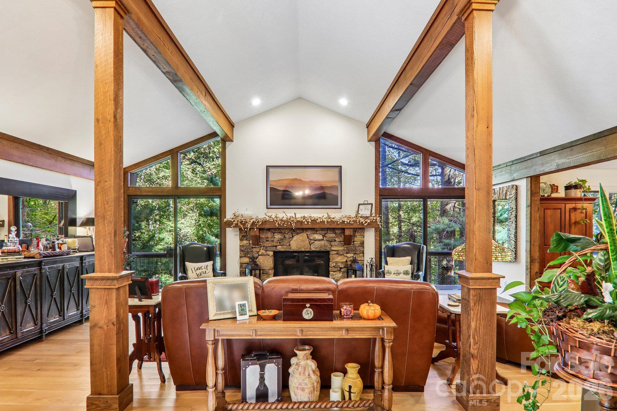 Wall of windows and cozy rock fireplace, reclaimed wooded beams and trim - 212 Pheasant Run, Hendersonville