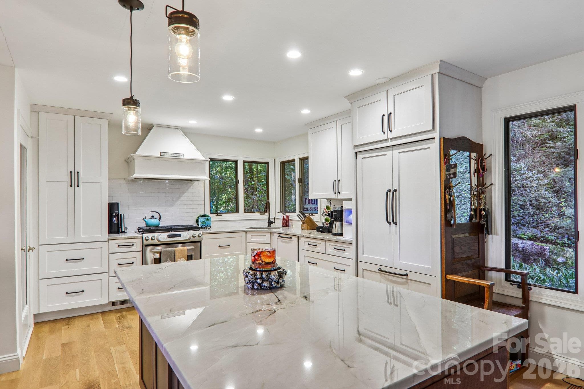 Custom cabinetry, tile back splash and many windows showcase this space. - 212 Pheasant Run, Hendersonville