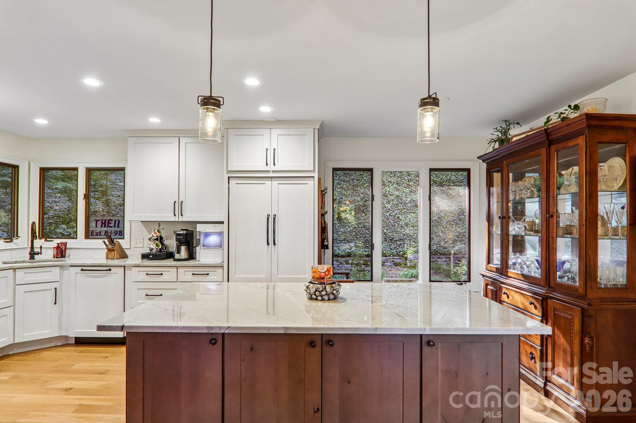 View of the kitchen island and spacious cooking space. - 212 Pheasant Run, Hendersonville