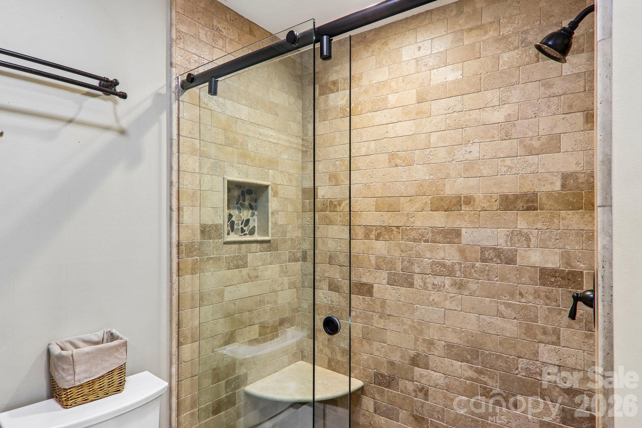Travertine tile in the lower level guest bathroom - 212 Pheasant Run, Hendersonville