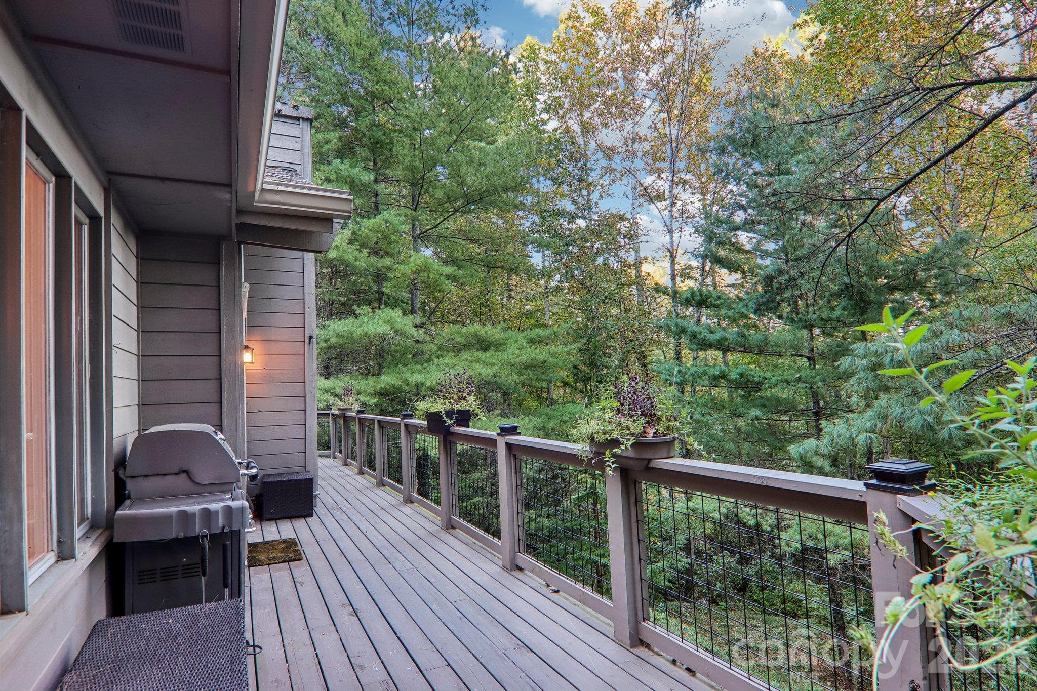 Rear deck of the home over looking the natural landscape - 212 Pheasant Run, Hendersonville