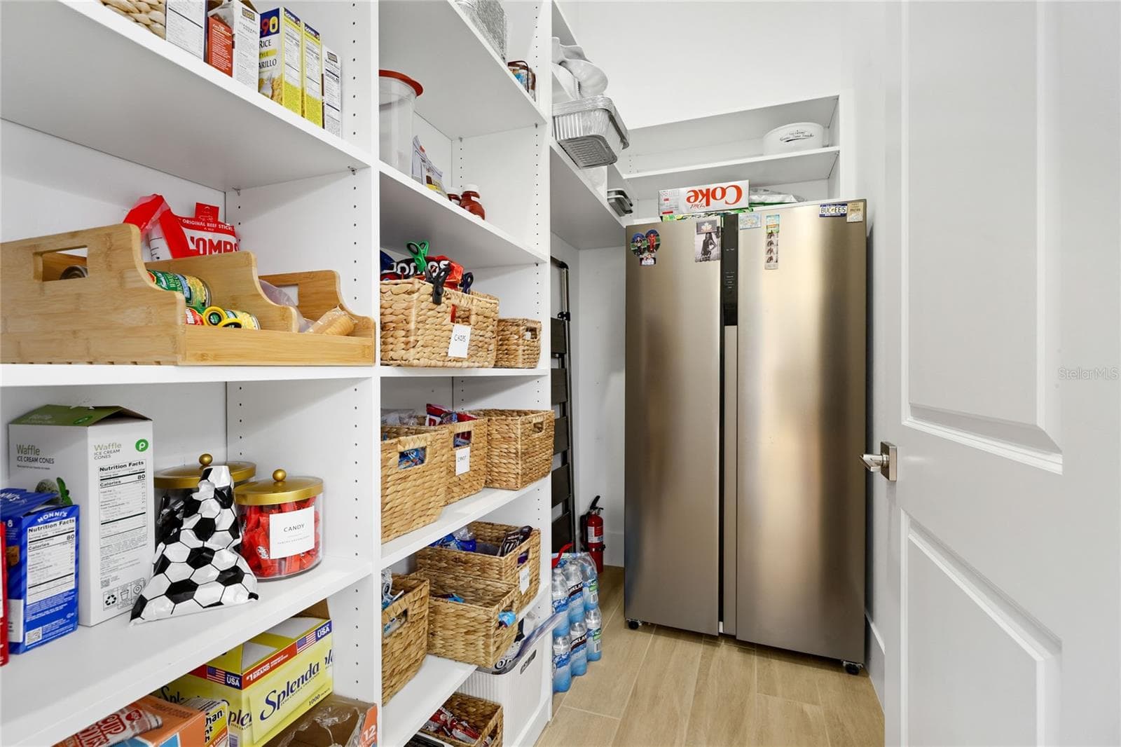 Pantry with custom built in shelving that accomodate an additional refrigerator. - 14726 EAGLE BRANCH DR, NOKOMIS