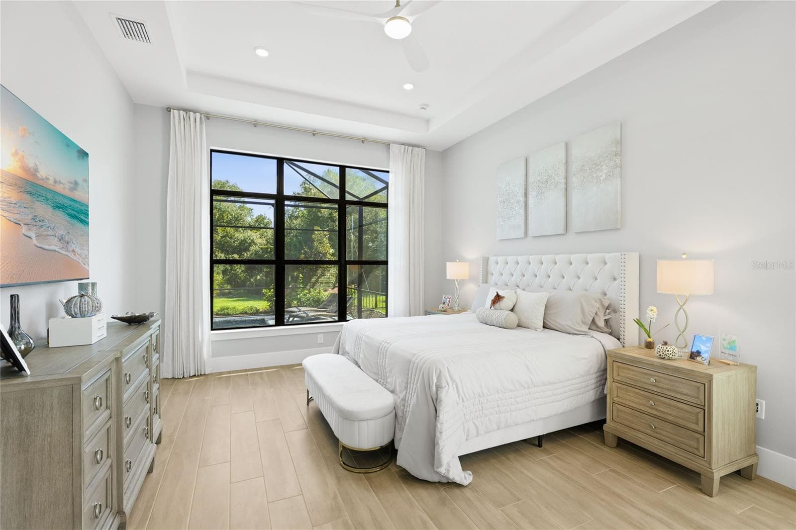 Primary Bedroom Ensuite with expansive windows overlooking the Lanai and custom pool. - 14726 EAGLE BRANCH DR, NOKOMIS