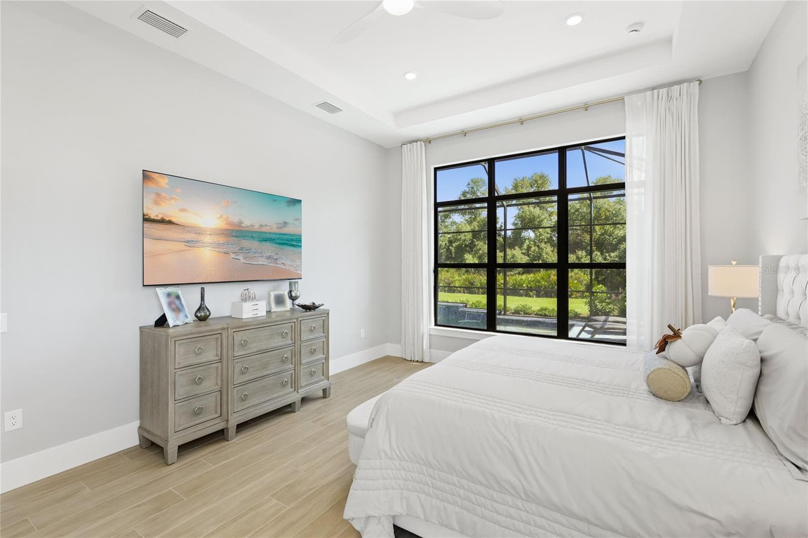 Primary Bedroom Ensuite with expansive windows overlooking the Lanai and custom pool. - 14726 EAGLE BRANCH DR, NOKOMIS