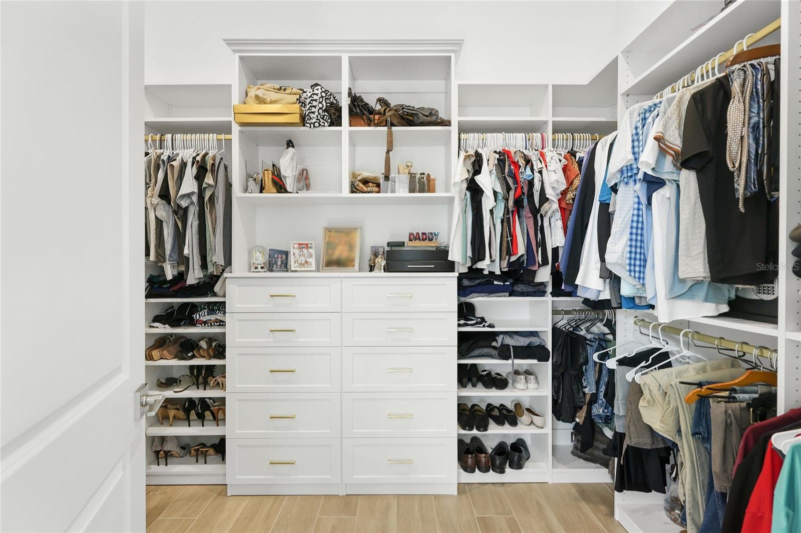 Primary Bathroom with walk in show with full glass enclosure, under lighting cabinetry, illuminating mirrors and expansive walk-in closet with custom shelving and cabinetry. - 14726 EAGLE BRANCH DR, NOKOMIS
