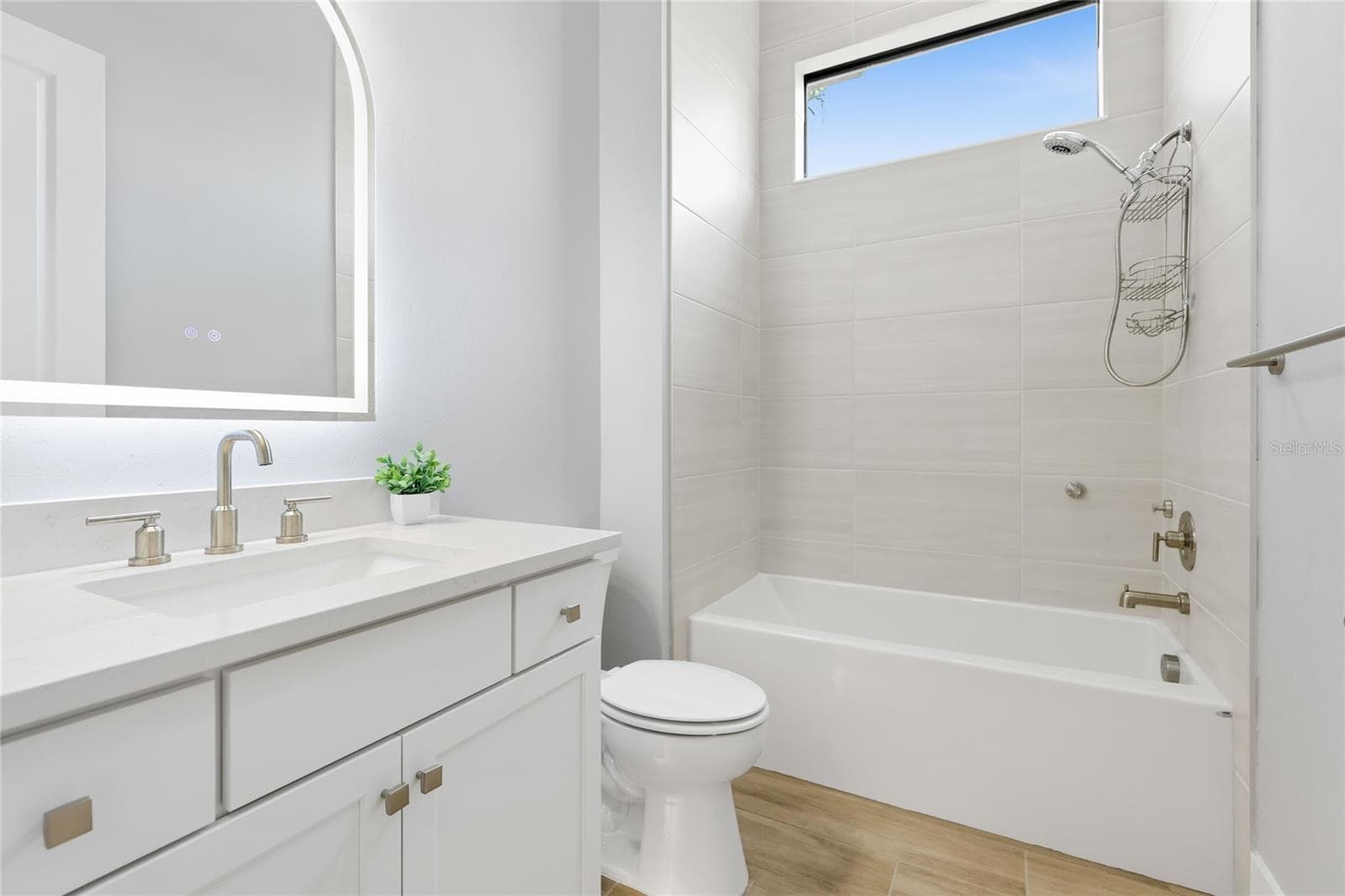 Bathroom 3 with Tub/Shower combination and under lighting cabinetry, illuminating mirror. - 14726 EAGLE BRANCH DR, NOKOMIS