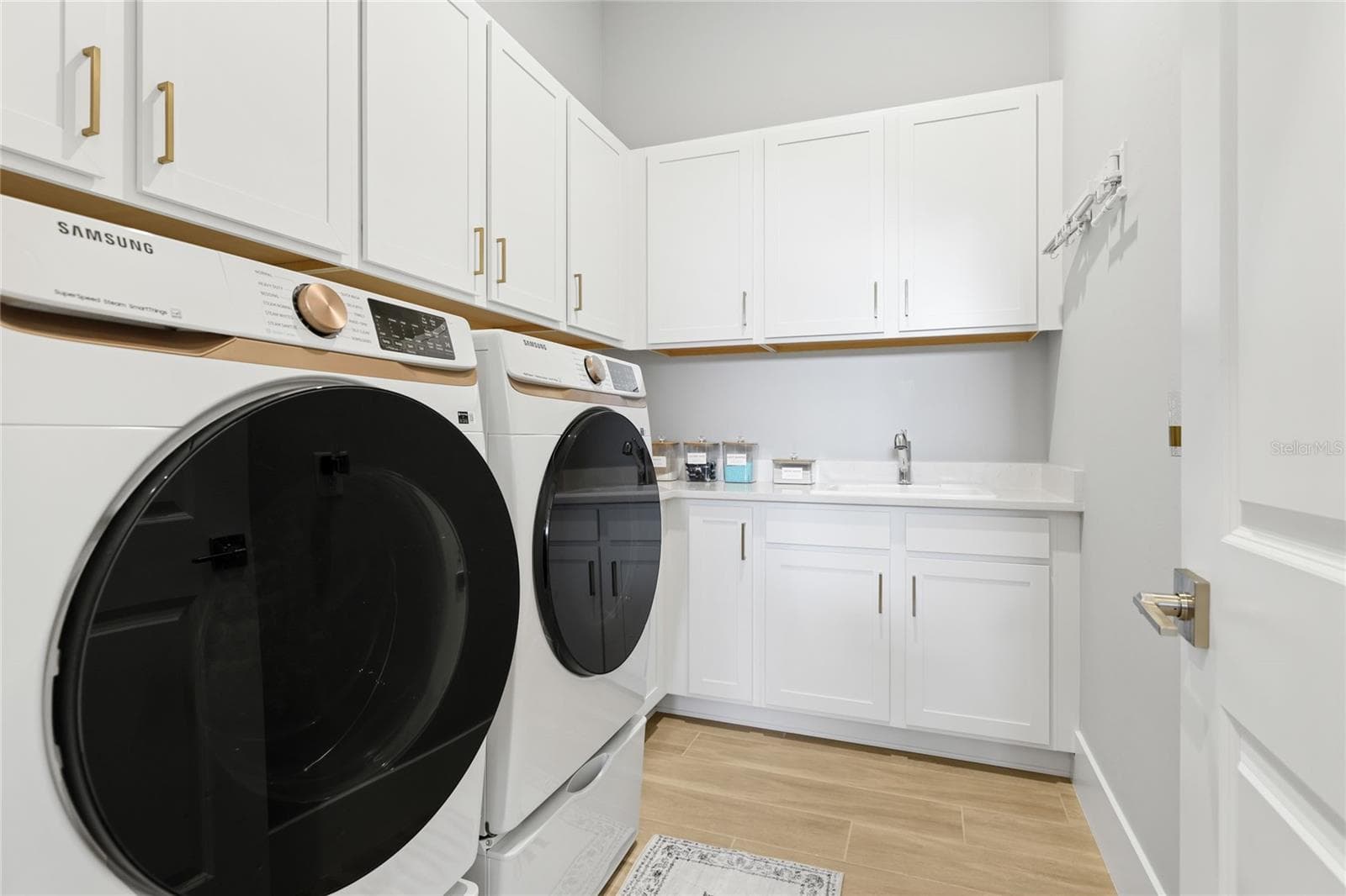 Dedicated laundry room with additional cabinetry and sink. - 14726 EAGLE BRANCH DR, NOKOMIS