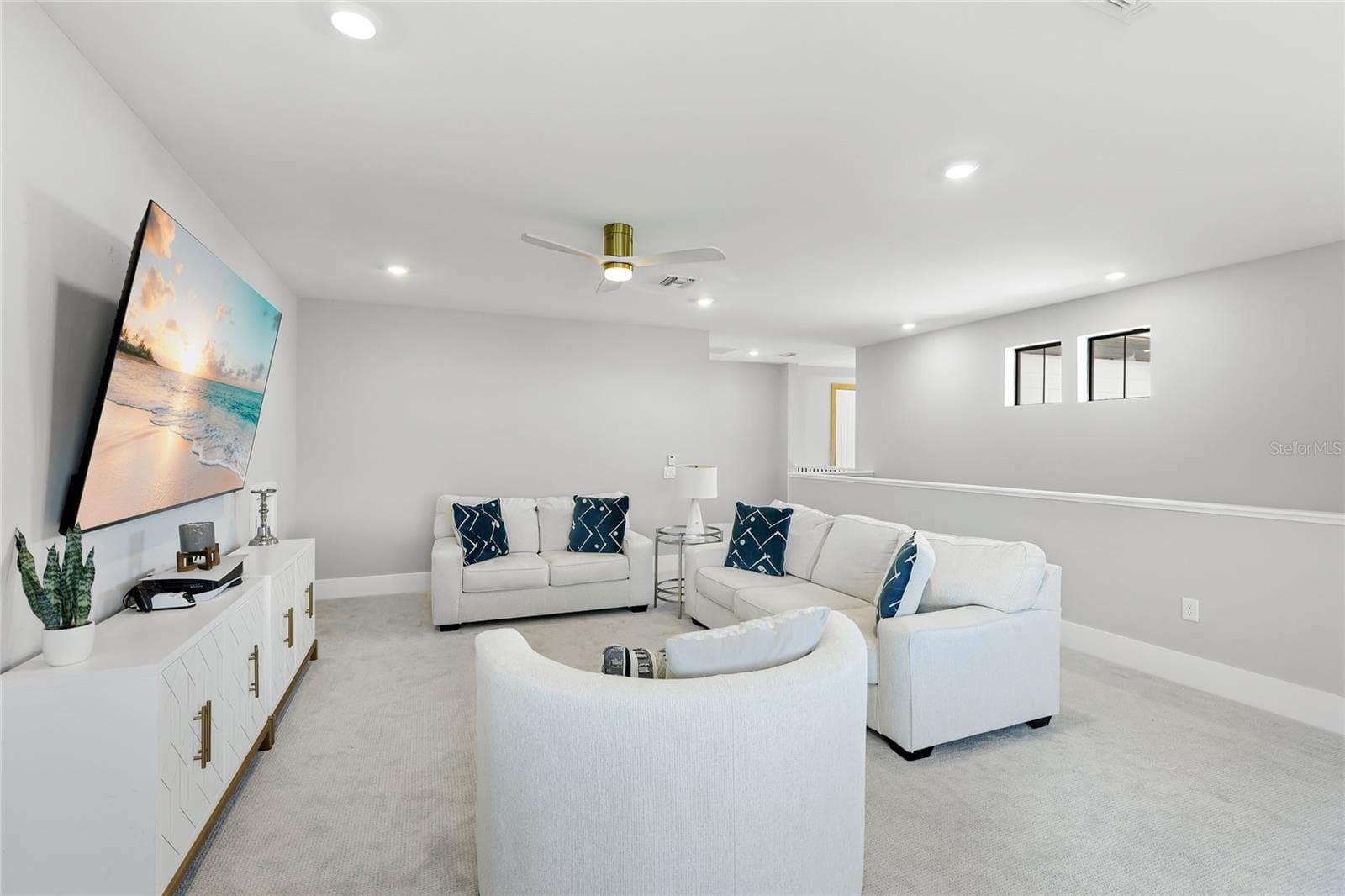 Light-filled bonus room featuring ample windows and transom windows, offering a versatile space ideal for a second TV room, home office, or additional gathering area—perfect for entertaining guests and enjoying quality time with family - 14726 EAGLE BRANCH DR, NOKOMIS