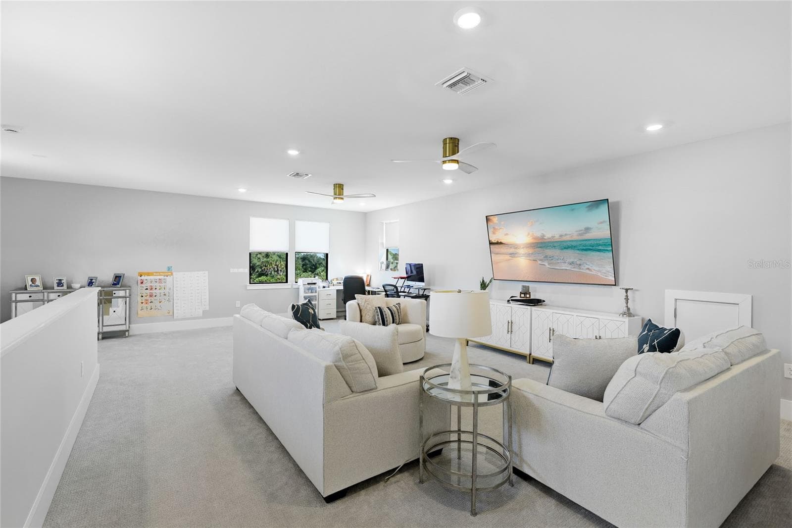 Light-filled bonus room featuring ample windows and transom windows, offering a versatile space ideal for a second TV room, home office, or additional gathering area—perfect for entertaining guests and enjoying quality time with family - 14726 EAGLE BRANCH DR, NOKOMIS
