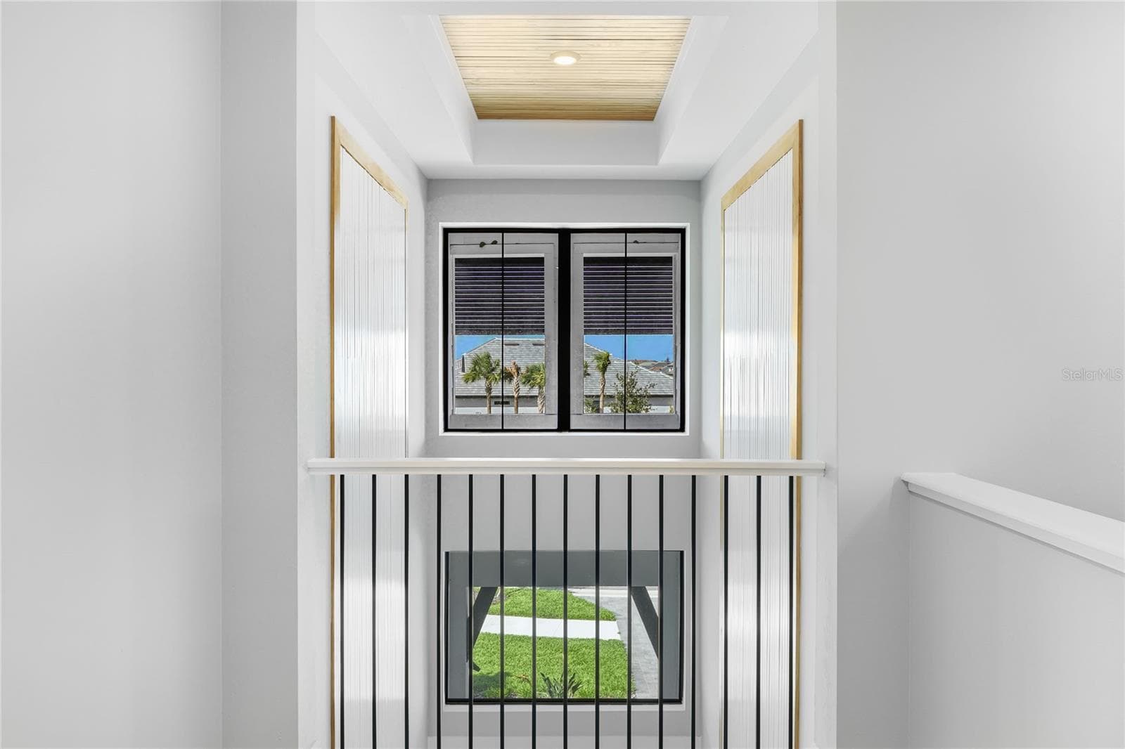 Overlook area from the second story with views of the custom feature wall looking out to the front of the home and private cul-de-sac. - 14726 EAGLE BRANCH DR, NOKOMIS