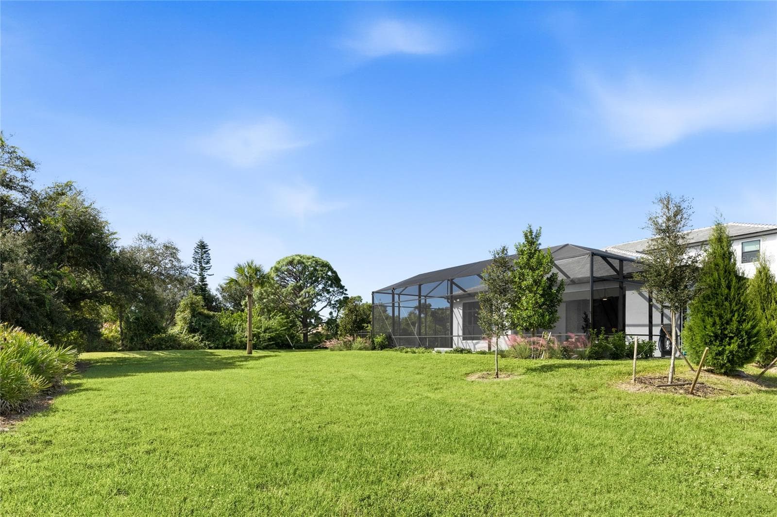 Rear of home is lush landscaping. - 14726 EAGLE BRANCH DR, NOKOMIS