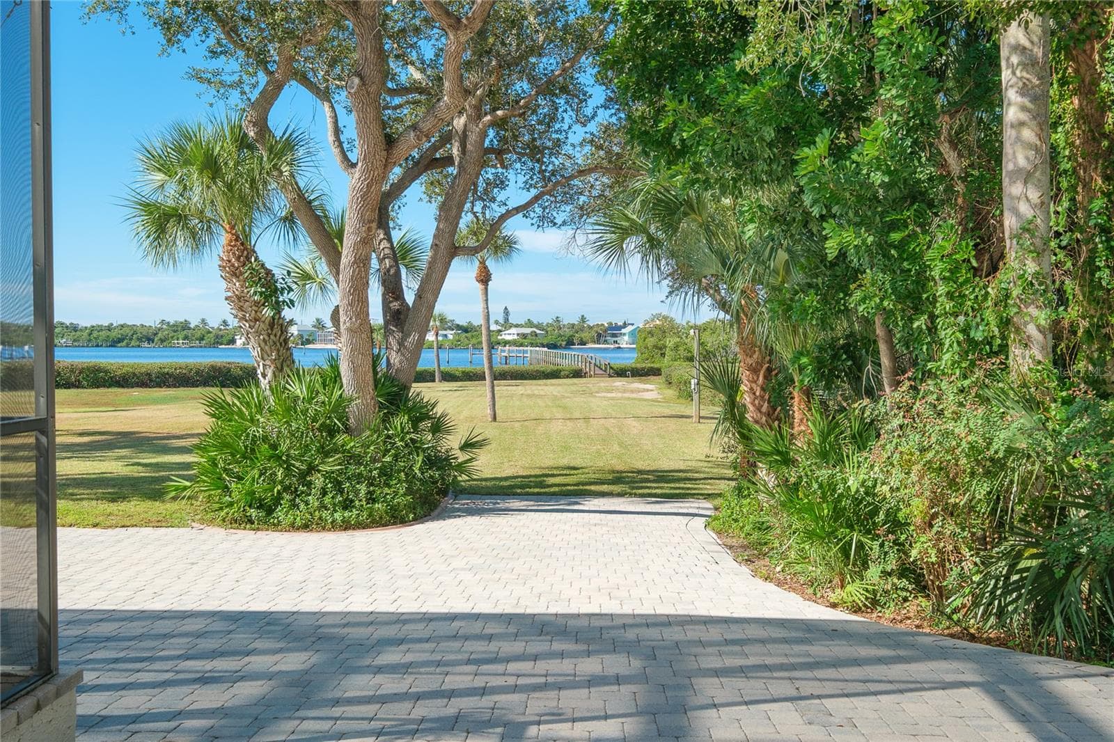 Spacious backyard extends to a dock on Lemon Bay - 1930 BAYSHORE DR, ENGLEWOOD