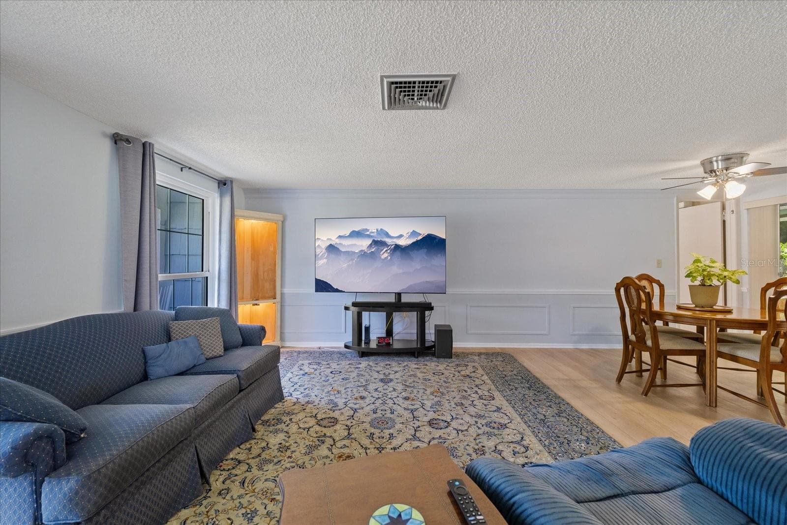 Living room and connecting dining - 8710 ARROWHEAD DR, HUDSON
