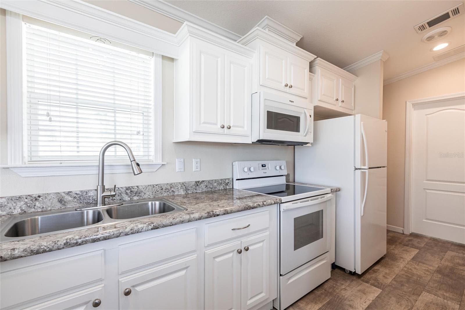Kitchen with white cabinets and appliances - 1329 TROUT, PUNTA GORDA
