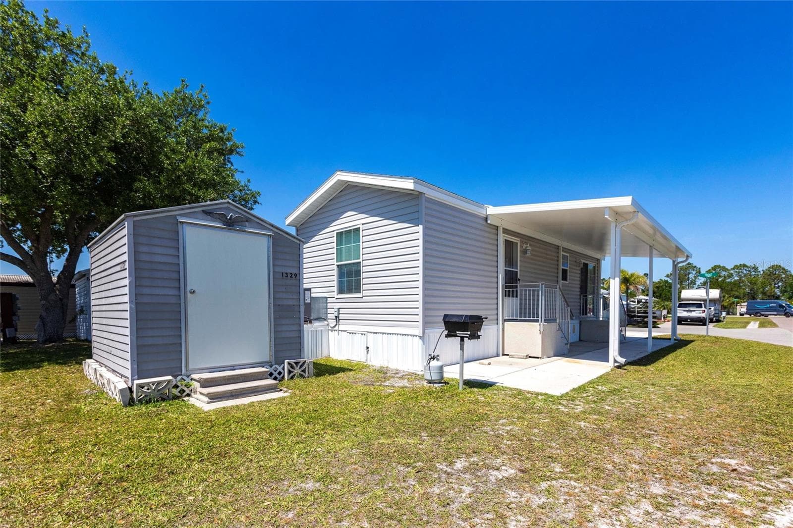 Side of home with shed and bbq - 1329 TROUT, PUNTA GORDA