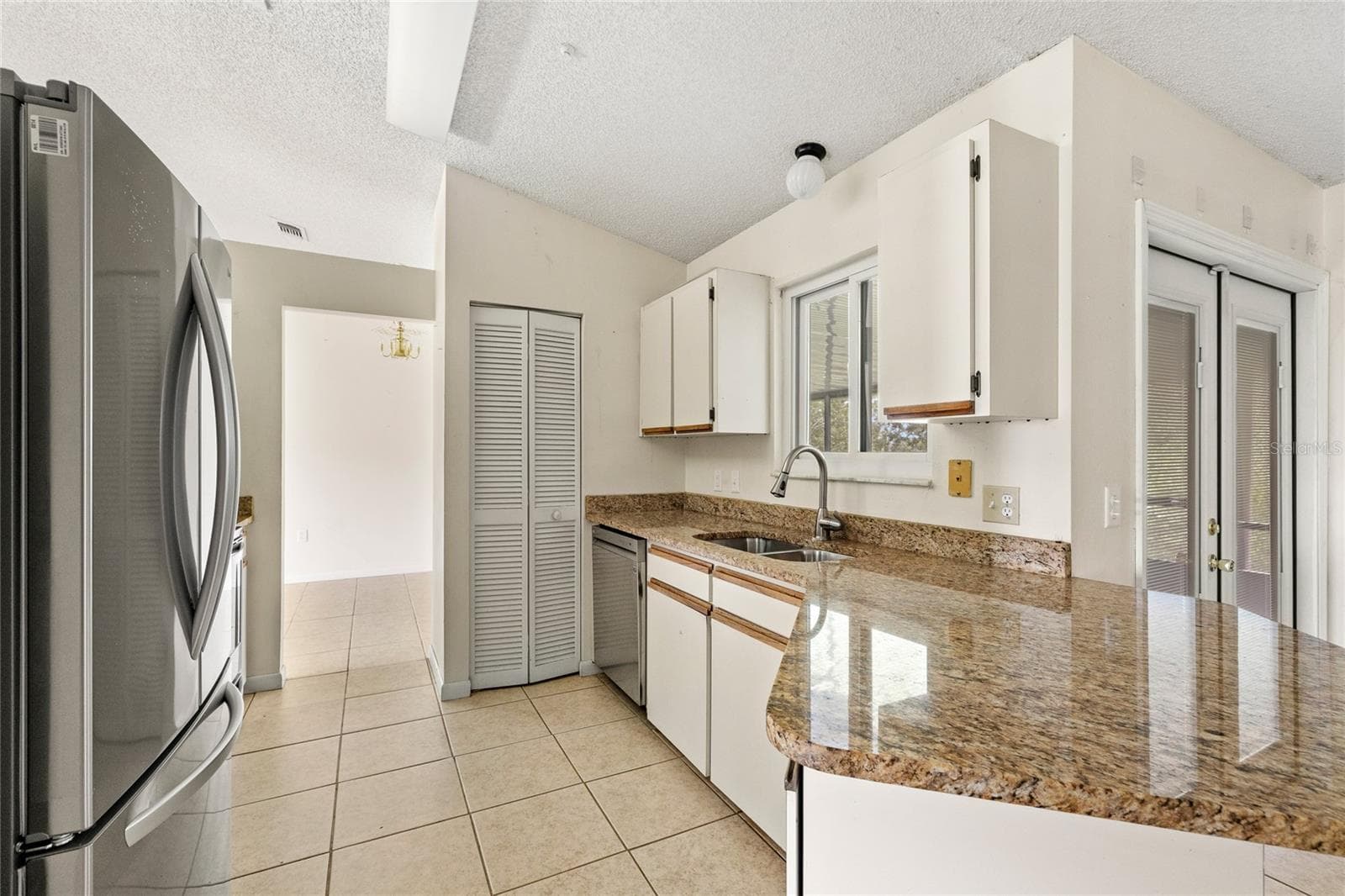 Kitchen with stainless steel appliances and granite counters. - 1273 GLADSTONE DR, DELTONA