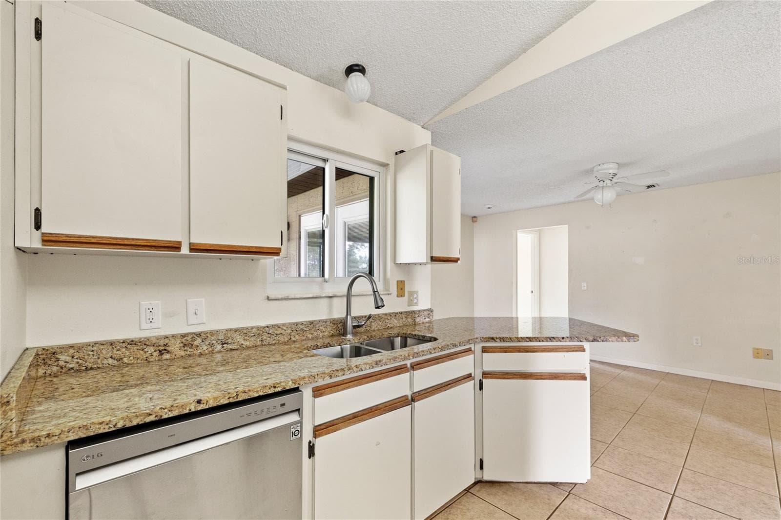 Kitchen with stainless steel appliances and granite counters. - 1273 GLADSTONE DR, DELTONA
