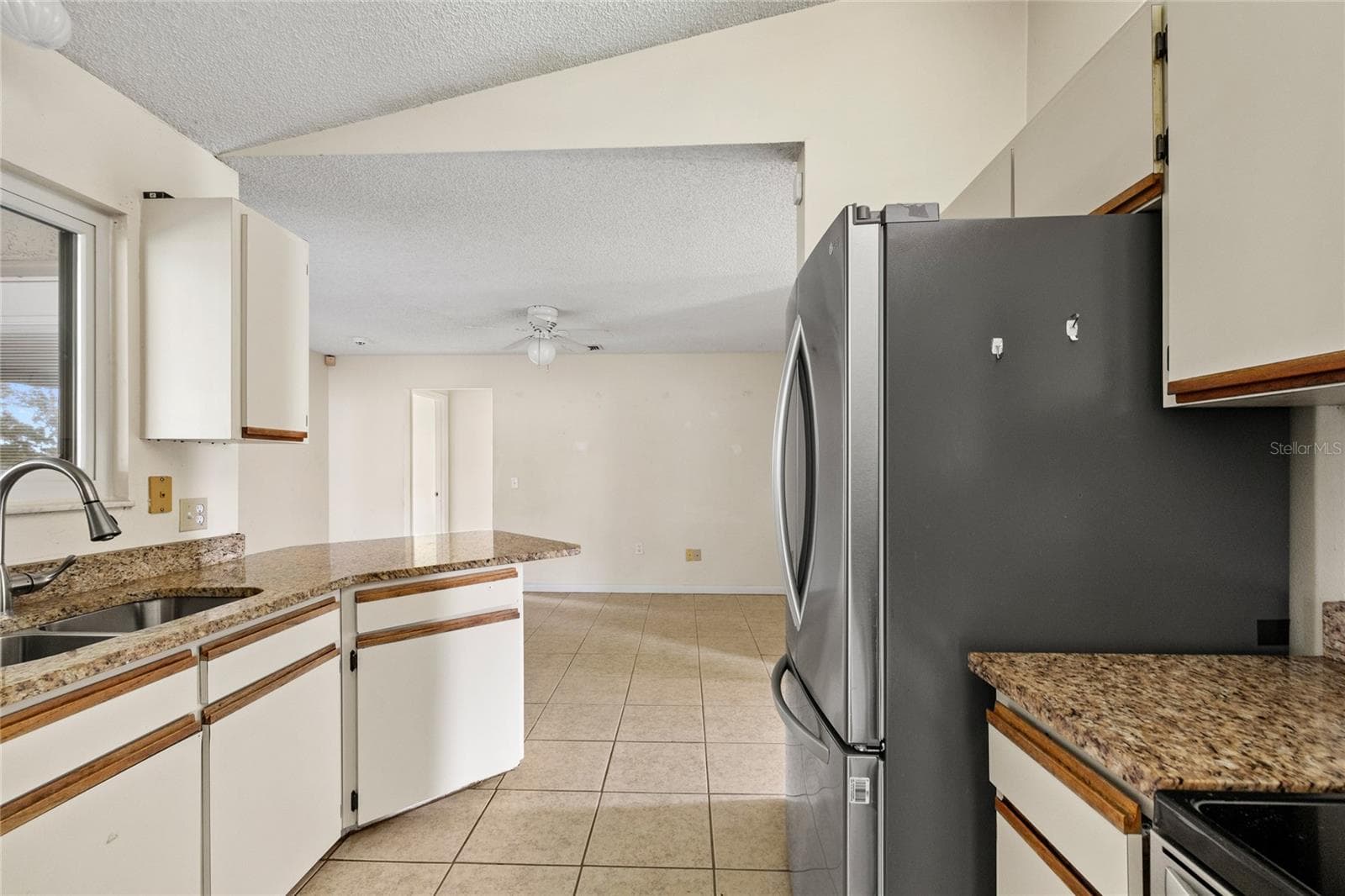 Kitchen with stainless steel appliances and granite counters. - 1273 GLADSTONE DR, DELTONA