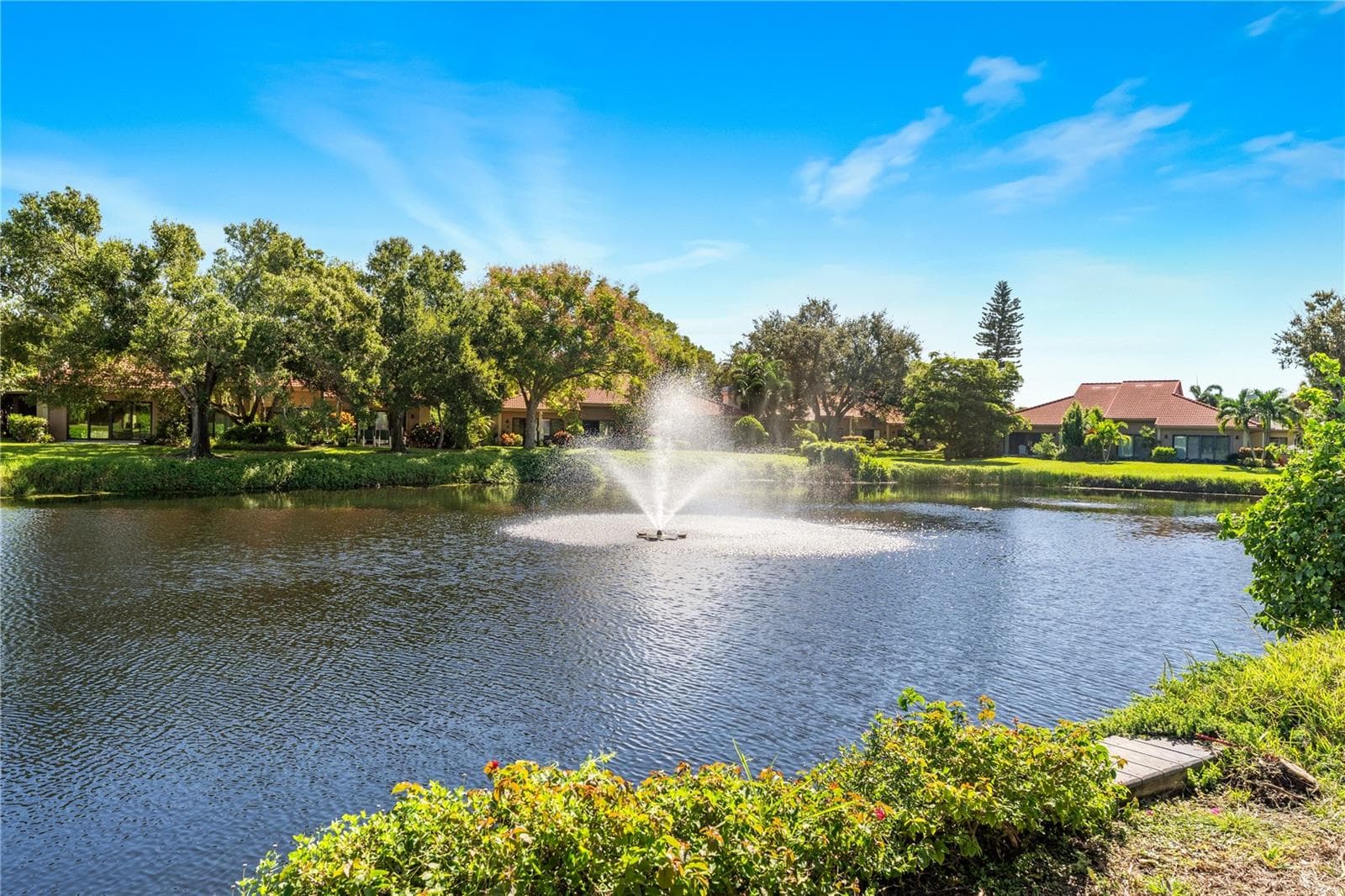 Direct lake views across the community's only seawall-lined water section. - 1720 KESTRAL PARK WAY S #49, SARASOTA