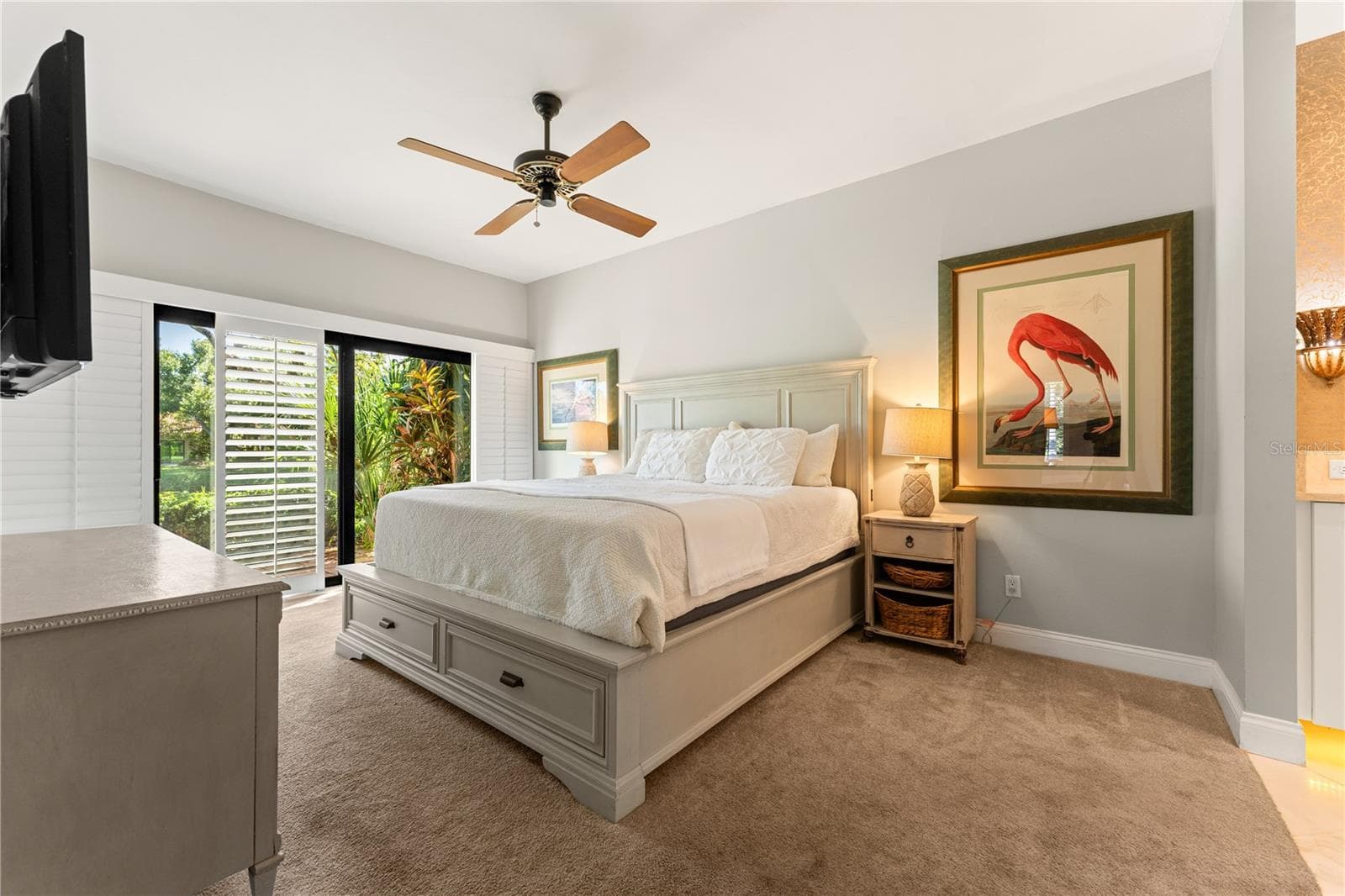 Primary suite featuring natural light and ample wall space, with outdoor access. - 1720 KESTRAL PARK WAY S #49, SARASOTA