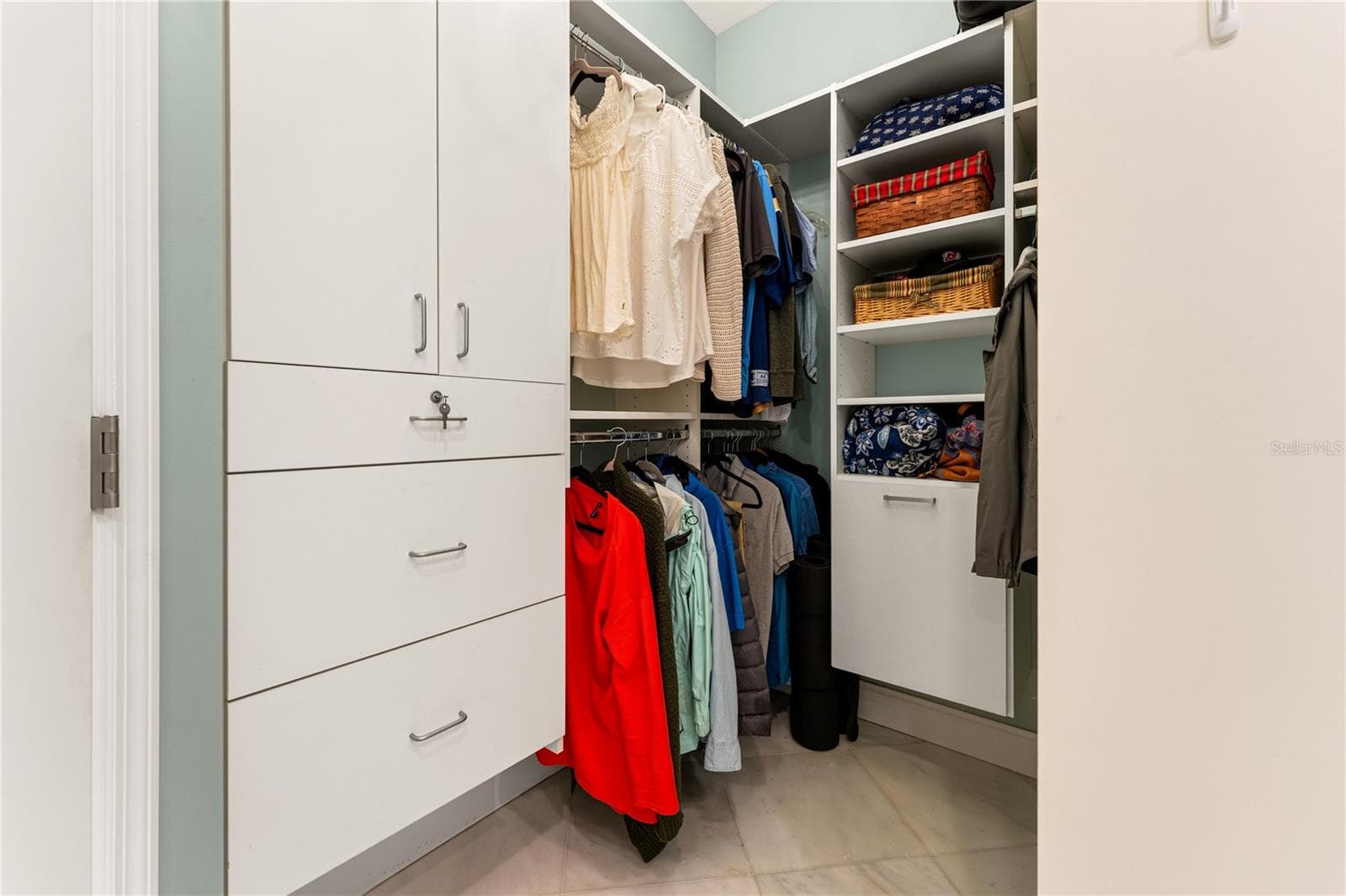Custom-fitted walk-in closet with built-in shelving and drawers. - 1720 KESTRAL PARK WAY S #49, SARASOTA
