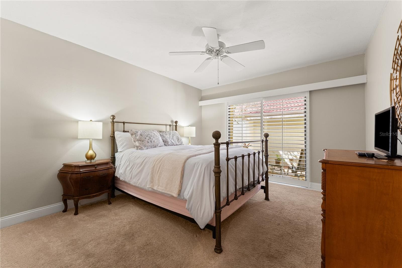 Front guest bedroom with closet, with outdoor access, and sliding glass door. - 1720 KESTRAL PARK WAY S #49, SARASOTA