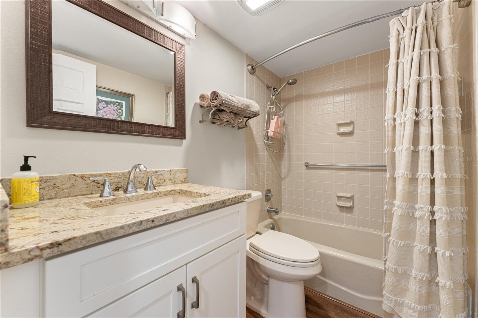 Second full bathroom with stone-surfaced vanity and tub. - 1720 KESTRAL PARK WAY S #49, SARASOTA