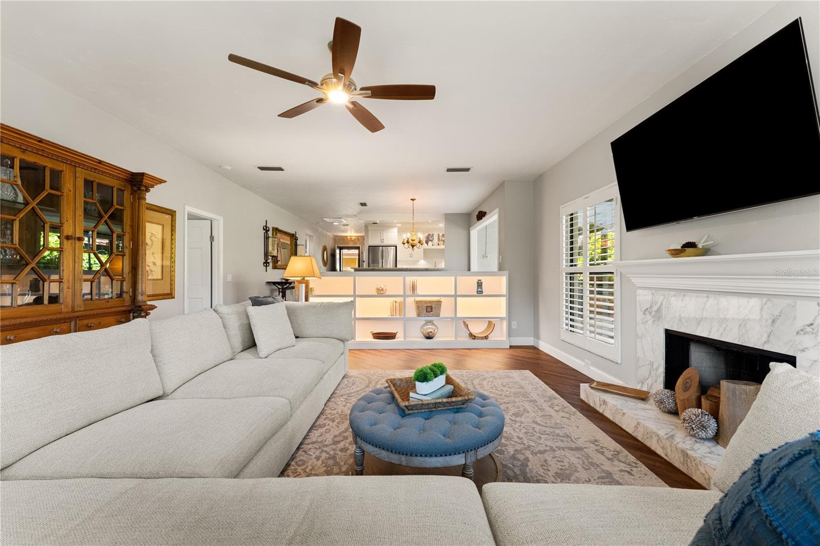 Living room perspective highlighting soaring ceilings and natural light - 1720 KESTRAL PARK WAY S #49, SARASOTA