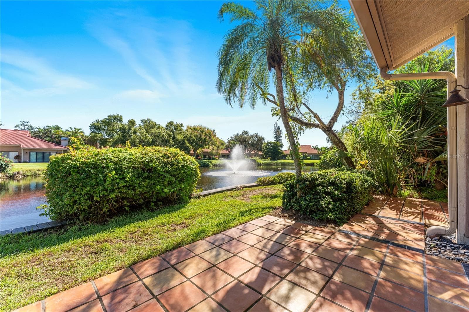 Serene lake frontage and active fountain viewed from the back. - 1720 KESTRAL PARK WAY S #49, SARASOTA