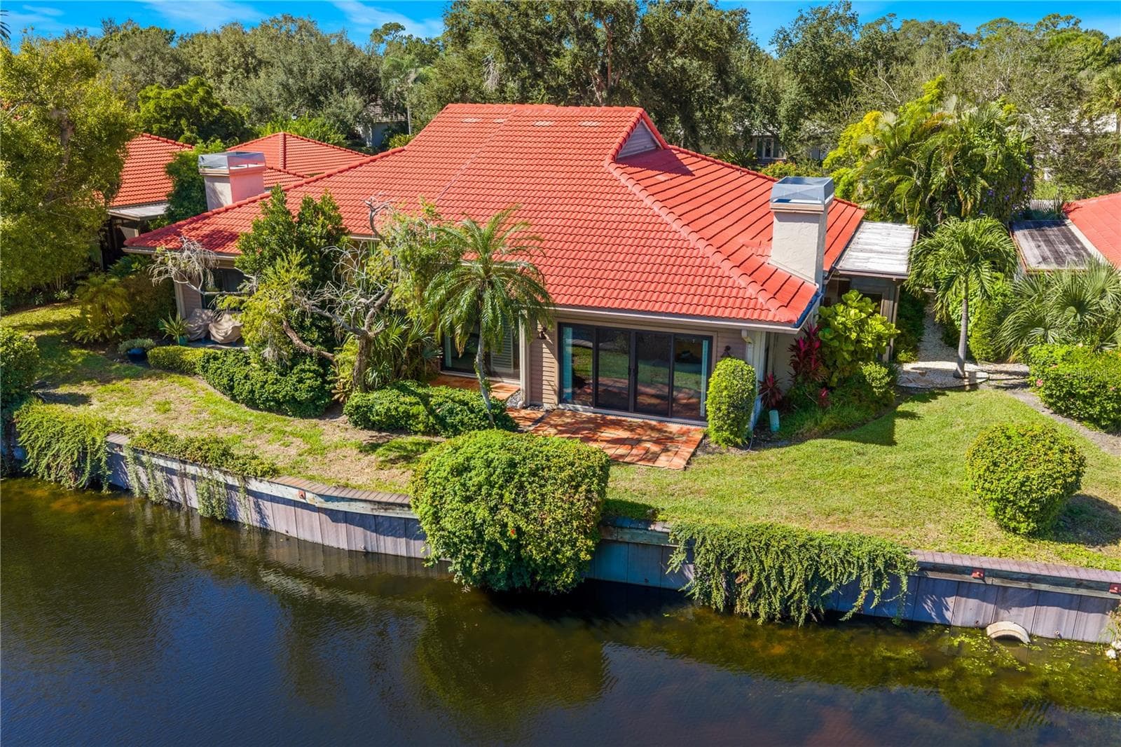 Aerial overview showing 2022 tile roof and waterfront lot placement. - 1720 KESTRAL PARK WAY S #49, SARASOTA