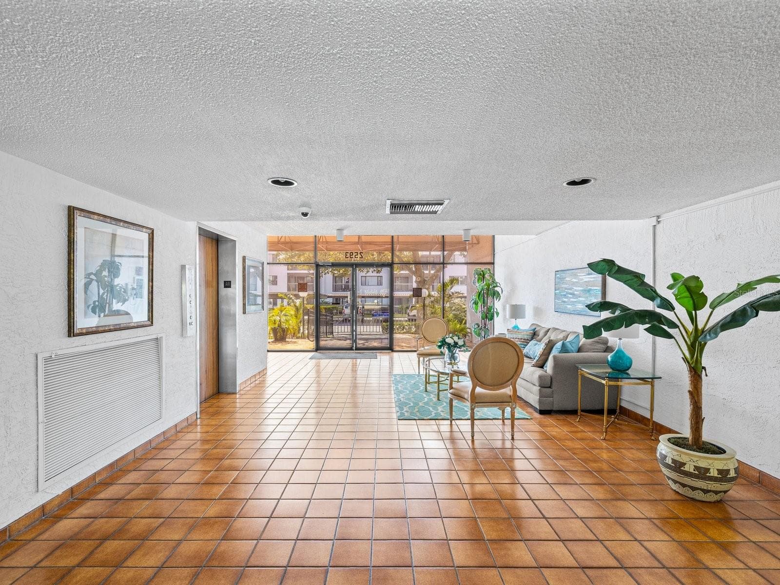 Building entry on main floor is security keyed entry with inviting sitting area and elevator on the left - 2593 COUNTRYSIDE BLVD #7304, CLEARWATER
