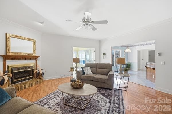 Spacious open living room with beautiful floors;  traffic flows to breakfast room and kitchen on one side, sunroom on another, and access to the guest bath and secondary bedrooms in another direction.  Open yet cozy with gas fire logs in the fireplace. - 244 Ruth Boulevard, Peachland
