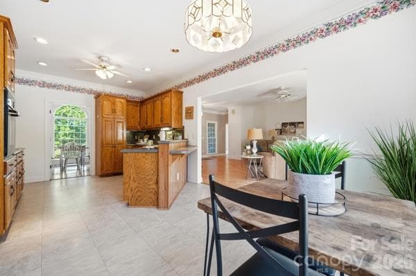 Taking a look at the kitchen from the breakfast area which includes a breakfast bar if you want to use it, bountiful workspace for preparing meals and a peep into the dining room. - 244 Ruth Boulevard, Peachland