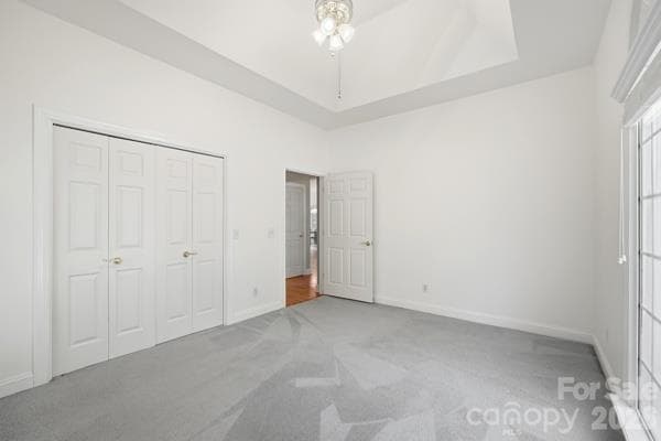Front bedroom with palladium window for tons of natural light.  Tray ceiling is extra feature.  Large closet.  One of two bedroom areas with carpet. - 244 Ruth Boulevard, Peachland