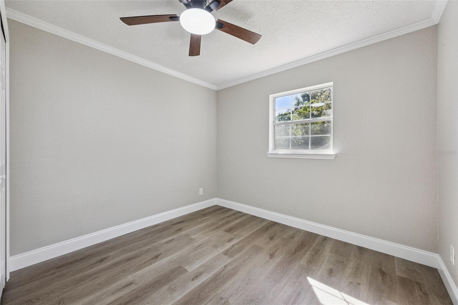 Secondary Bedroom View: Well-appointed guest room featuring durable vinyl plank flooring, neutral paint, and updated lighting - 720 GEORGIA AVE, LONGWOOD