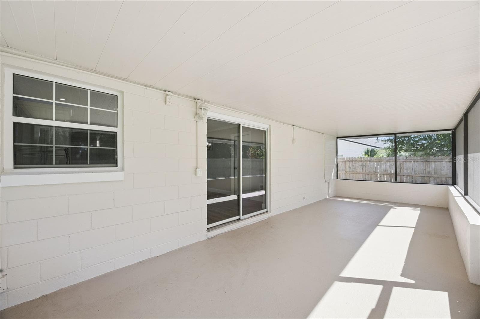 Covered Screened Lanai: Spacious covered and screened porch with sliding glass door access and fresh neutral flooring, perfect for outdoor outdoor living - 720 GEORGIA AVE, LONGWOOD