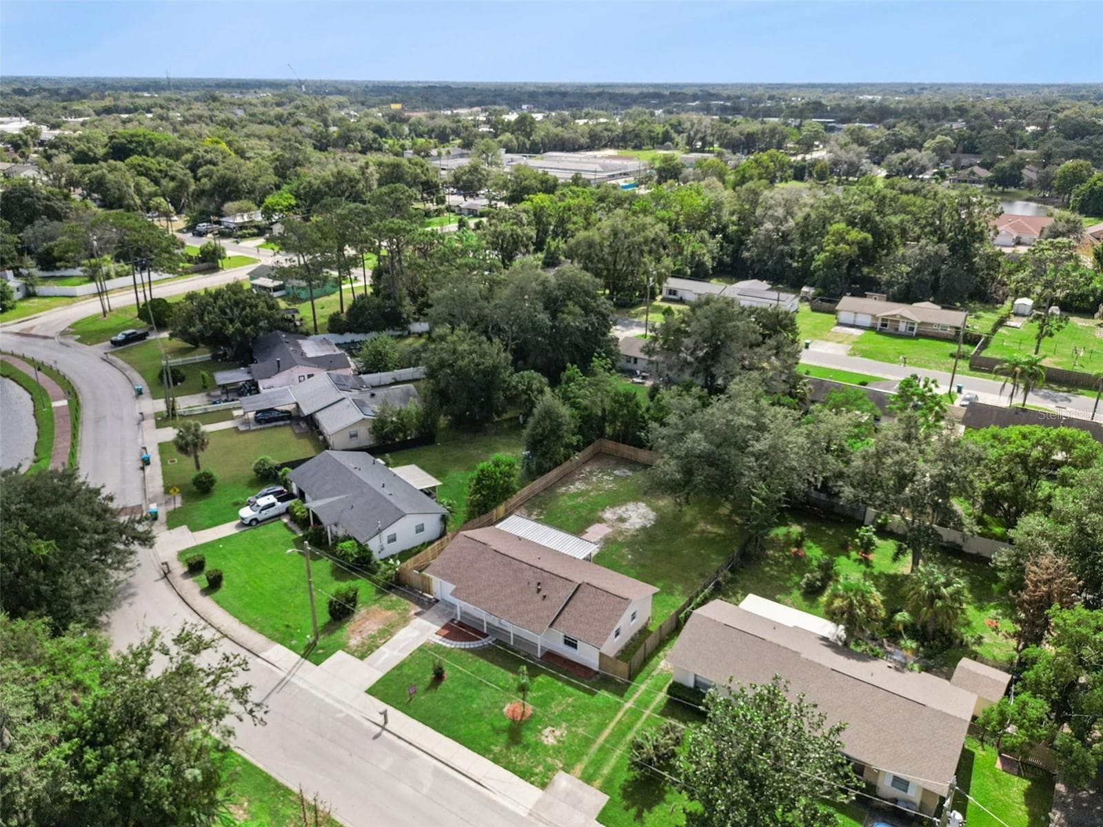 Aerial Neighborhood Overview: Elevated aerial shot highlighting the home's location within the surrounding tree-lined neighborhood. - 720 GEORGIA AVE, LONGWOOD